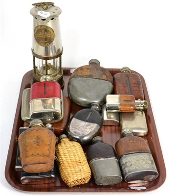 Lot 106 - A collection of various hip flasks and a miners lamp