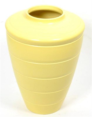 Lot 115 - Keith Murray (New Zealander 1892-1981) for Wedgwood, a tapering vase, ribbed body, pale yellow...