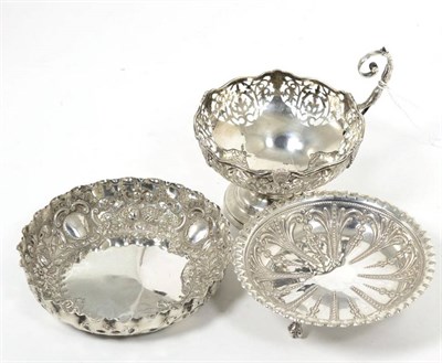 Lot 129 - A Victorian repousse silver dish, London 1892; a pierced bowl with single handle, Mappin & Webb...