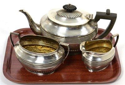 Lot 163 - An Edwardian silver three piece tea service, Sheffield, 1902/04/06, reeded and fluted...