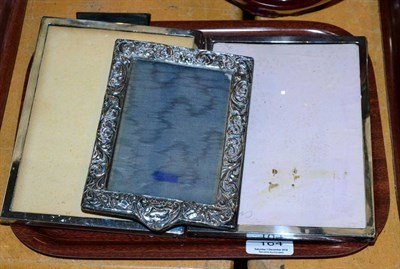 Lot 164 - A pair of plain rectangular silver photograph frames; and another decorative example