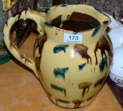 Lot 173 - A slip glaze earthenware jug