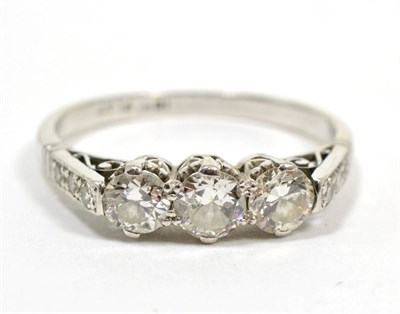 Lot 201 - An early twentieth century diamond three stone ring, with diamond set shoulders, total...