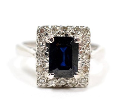 Lot 213 - A sapphire and diamond cluster ring, finger size H, stamped '18CT', 5.0g