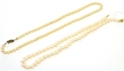 Lot 242 - A cultured pearl necklace with 9 carat gold ball clasp, length 45cm and a simulated pearl...