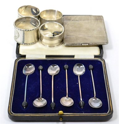 Lot 265 - A cased set of silver coffee bean spoons; a silver cigarette case; three silver napkin rings; and a