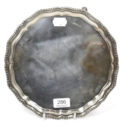 Lot 286 - A shaped circular silver salver of George III style, with gadrooned border