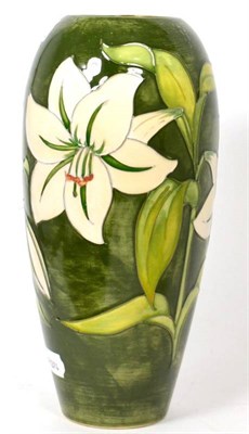 Lot 317 - A Walter Moorcroft Bermuda lily design vase, on a green ground, impressed factory marks and...