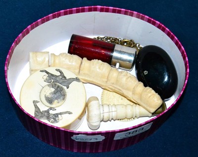 Lot 383 - A cranberry smelling salts bottle; a Victorian ivory hand seal; a Japanese Meiji period ivory...