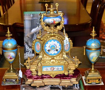 Lot 408 - A French gilt metal and porcelain mounted clock garniture, late 19th century, on gilt wood stand