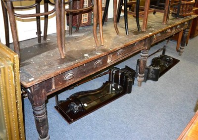 Lot 1130 - A very large farmhouse kitchen table, one side fitted with four drawers, on turned supports
