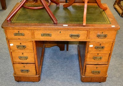 Lot 1141 - An early 20th century oak twin pedestal desk