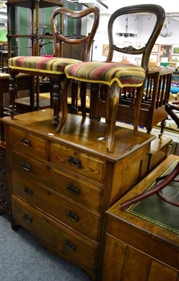 Lot 1143 - An oak chest of drawers and two Victorian mahogany balloon back chairs