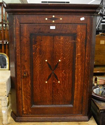 Lot 1155 - A 19th century oak corner cupboard