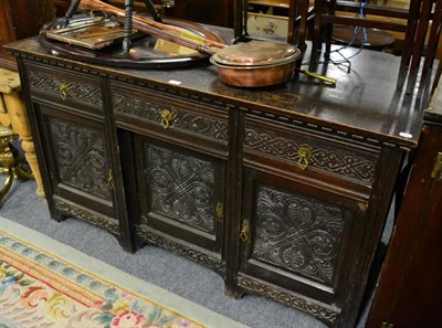 Lot 1157 - A carved oak sideboard