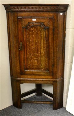 Lot 1163 - An oak corner cupboard on stand