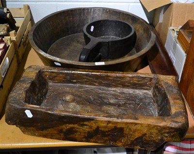 Lot 1177 - A very large dug out bowl; a large treen grain measure; another rectangular dug out bowl and a...