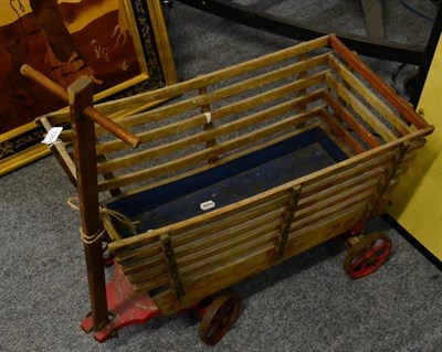 Lot 1201 - A mid-20th century child's wooden cart with tow bar and iron wheels, built by joiner in Embsay,...