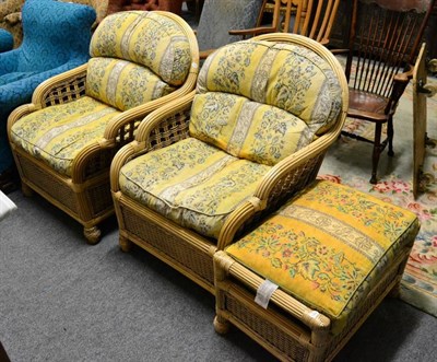 Lot 1204 - A pair of modern wicker conservatory chairs and matching footstool