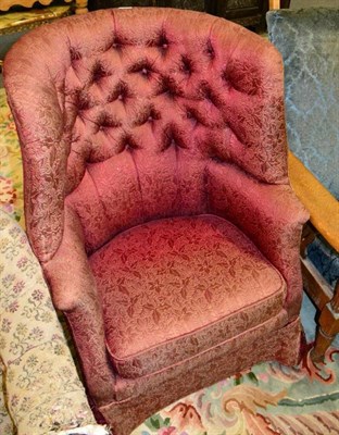 Lot 1207 - A barrel back upholstered armchair