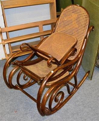 Lot 1215 - An Austrian bentwood rocking chair and matching footstool, by Thonet of Vienna, footstool...