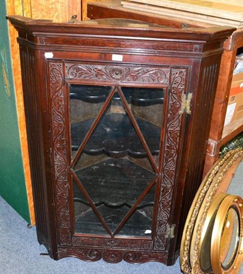 Lot 1216 - A glazed hanging oak corner cupboard