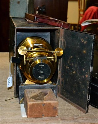 Lot 1223 - Magic Lantern brass 7'' lens with rack and pinion focussing in tin box, together with two boxes...