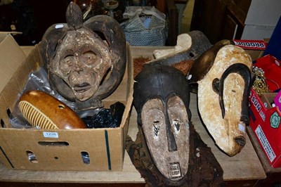 Lot 1226 - Four African carved wood tribal masks, including examples in the Yoruba and M'Pongwe manner,...