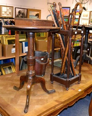 Lot 1286 - An oak tripod table and a stick stand with a collection of sticks