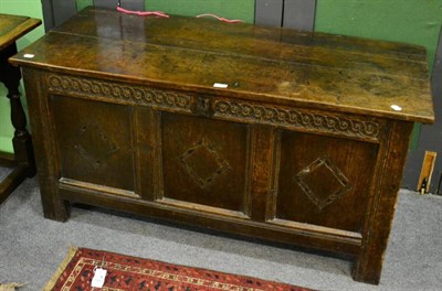 Lot 1333 - An early 19th century joined oak chest with hinged lid and three lozenge carved panels