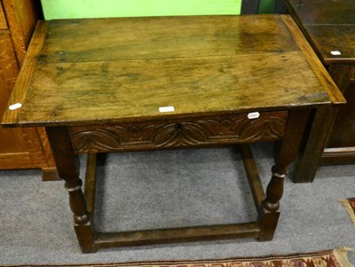 Lot 1334 - An English oak side table, late 17th/early 18th century, plank top with cleated ends, single...