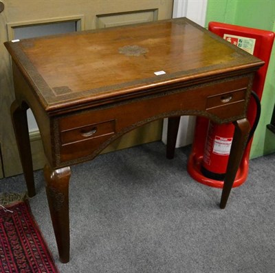 Lot 1344 - A 20th century walnut table with carved border above two small drawers