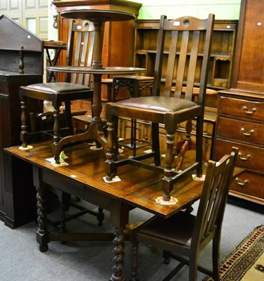 Lot 1350 - An oak draw leaf table and four chairs