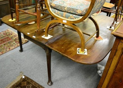 Lot 1365 - A George III mahogany dropleaf table on pad feet