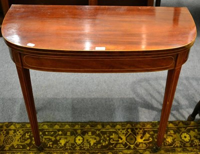 Lot 1372 - A late George III mahogany fold over tea table, on square tapering legs (a.f.)