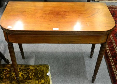 Lot 1374 - An early 19th century mahogany and boxwood strung fold over tea table, on reeded legs