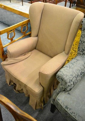 Lot 1389 - An early 20th century wingback armchair, recovered in striped fabric