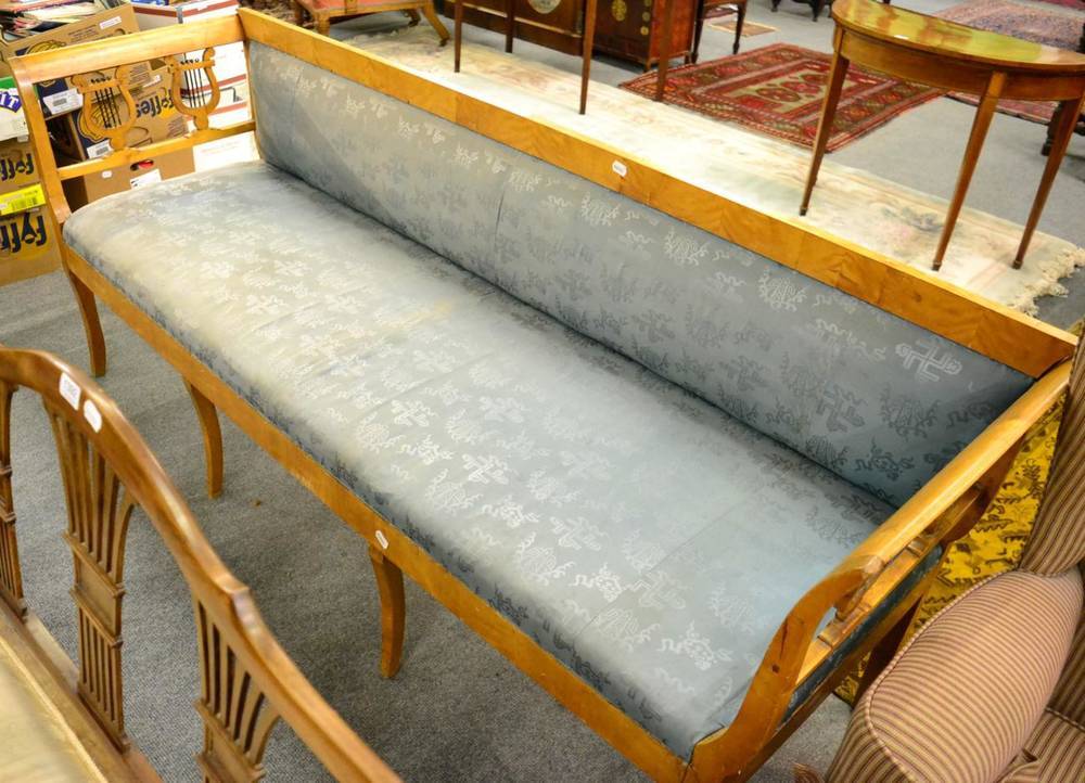 Lot 1390 - A 19th century Empire style satin-birch settee, with lyre end supports, outswept legs, 210cm long