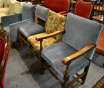 Lot 1404 - An oak open armchair with two similar side chairs and a further upholstered armchair (4)