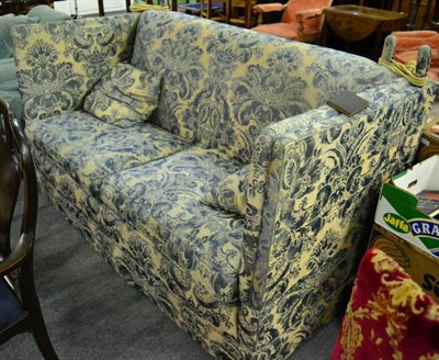 Lot 1413 - A feather filled Knole type sofa, upholstered in blue floral fabric