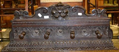 Lot 1425 - A carved wooden coat rack