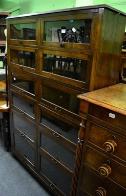 Lot 1446 - A glazed oak bookcase/cabinet with graduated up and over doors