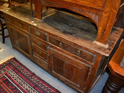 Lot 1454 - An 18th century oak low dresser, with six drawers, and two cupboard doors