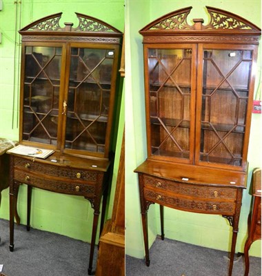 Lot 1469 - A pair of glazed display bookcases with blind fret carved drawer fronts