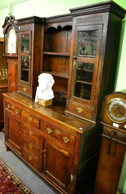 Lot 1471 - A George III oak enclosed dresser and rack, the rack with a pair of glazed side compartments