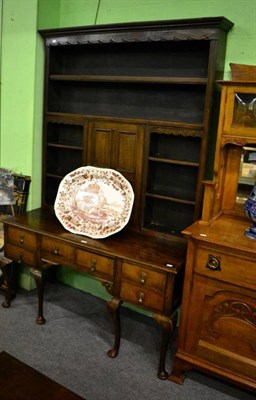 Lot 1474 - An oak dresser and rack on cabriole supports, the rack with central panelled cupboard