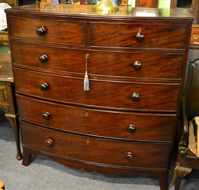 Lot 1483 - A mahogany bow front five height chest of drawers on bracket feet