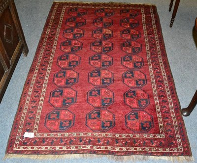 Lot 1493 - Turkmen rug North West Afghanistan, the madder field of ''elephant foot'' guls enclosed by...