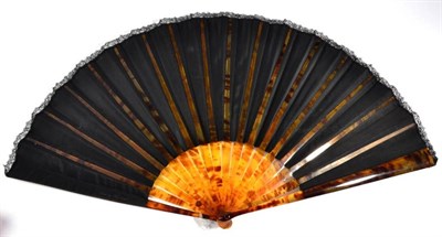 Lot 65 - A Circa 1875 Fan, with a painted black silk leaf, edged with black Chantilly lace, mounted à...