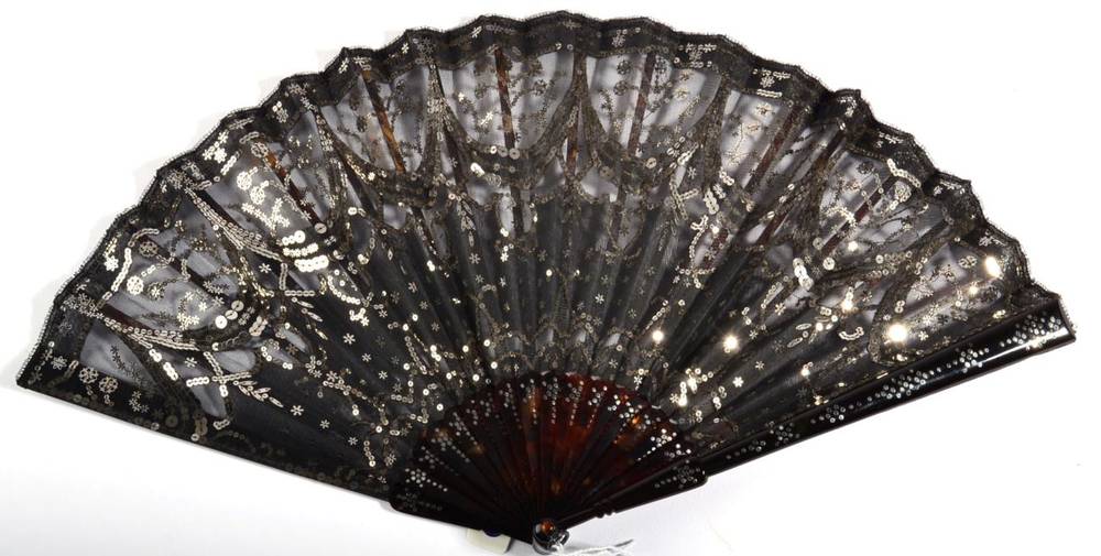 Lot 113 - A Circa 1905 Tortoiseshell Fan, the monture piqué, the black gauze leaf decorated in swags...